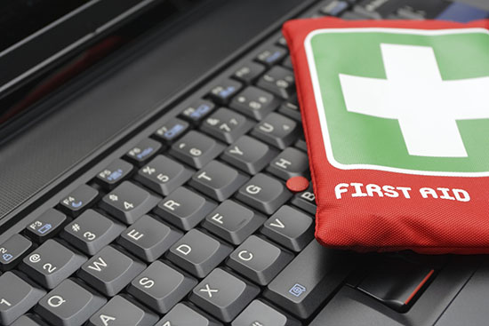 First aid kit on laptop keyboard